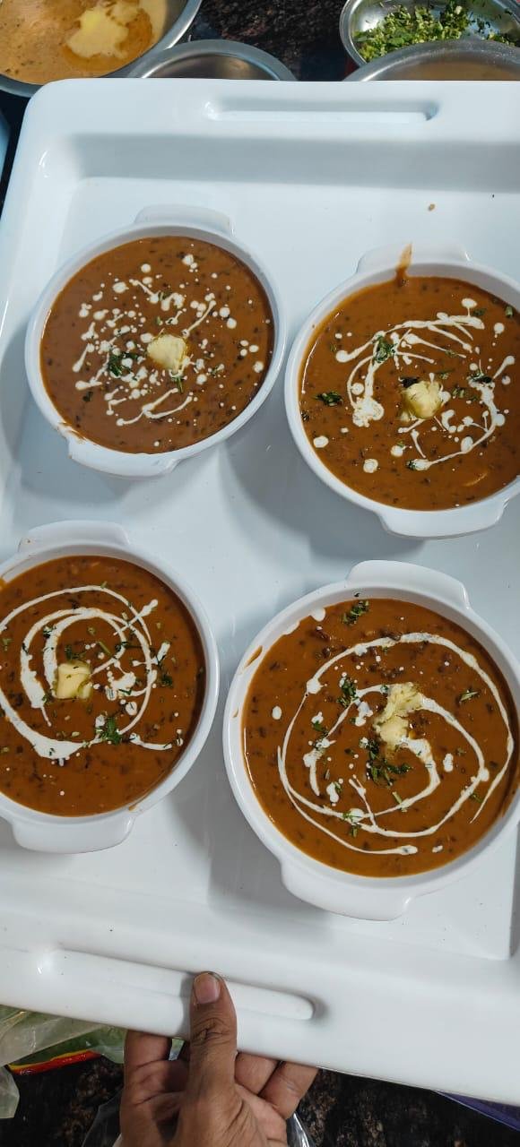 Four bowls of creamy dal makhani garnished with cream, butter, and coriander at Hillside Social Cafe